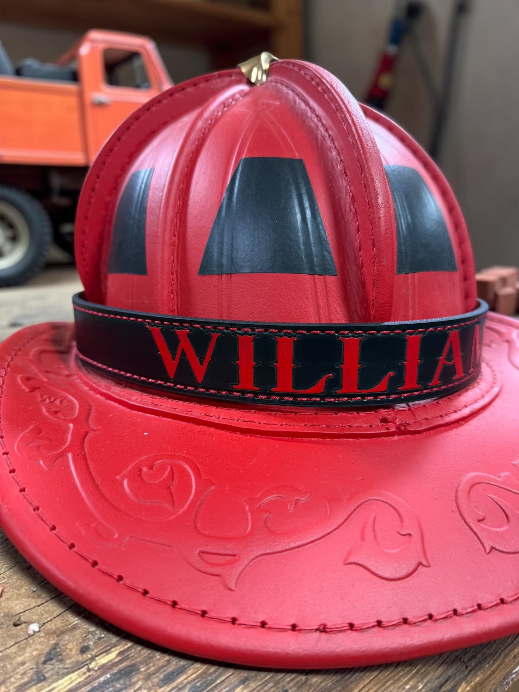 Personalized leather fire helmet band with red painted lettering — view 2